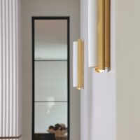 Vertical sconces, vertical tile and black frame window for good example of linear design
