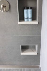 Gray large format shower tile, shaving niche