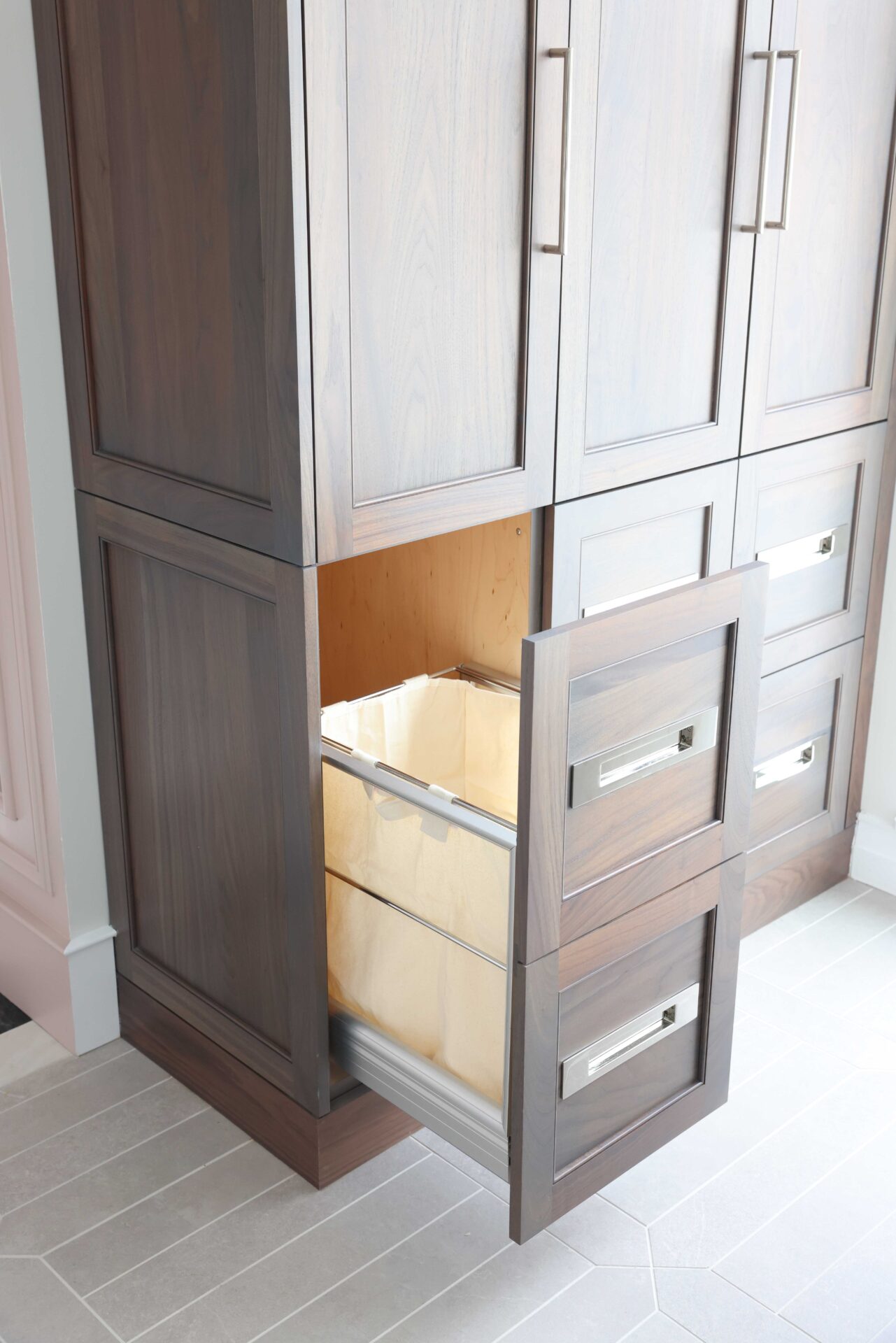 Walnut linen cabinet with pull-out laundry hamper drawer, polished nickel hardware