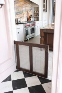 Pet door between kitchen and butler's pantry (facing into kitchen), cherry with metal mesh, black and white checkerboard tile floor