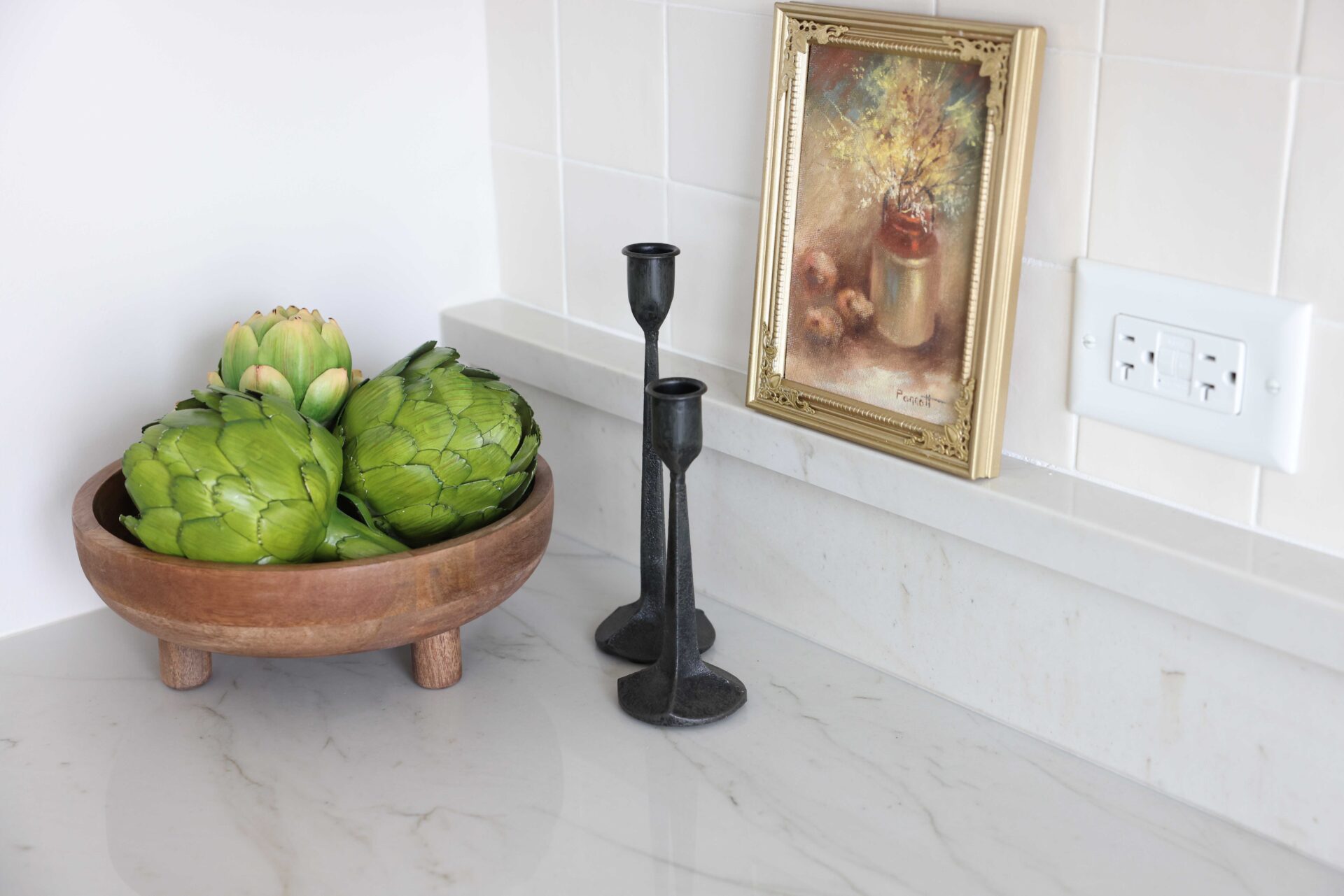 Quartzite countertop with backsplash shelf, white zellige tile backsplash