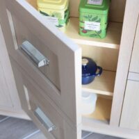 Rift cut white oak kitchen island with drawer facade for cabinet doors, shallow shelving