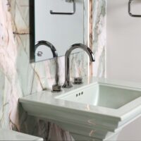 Green porcelain feature wall, floating mirror, titanium faucet