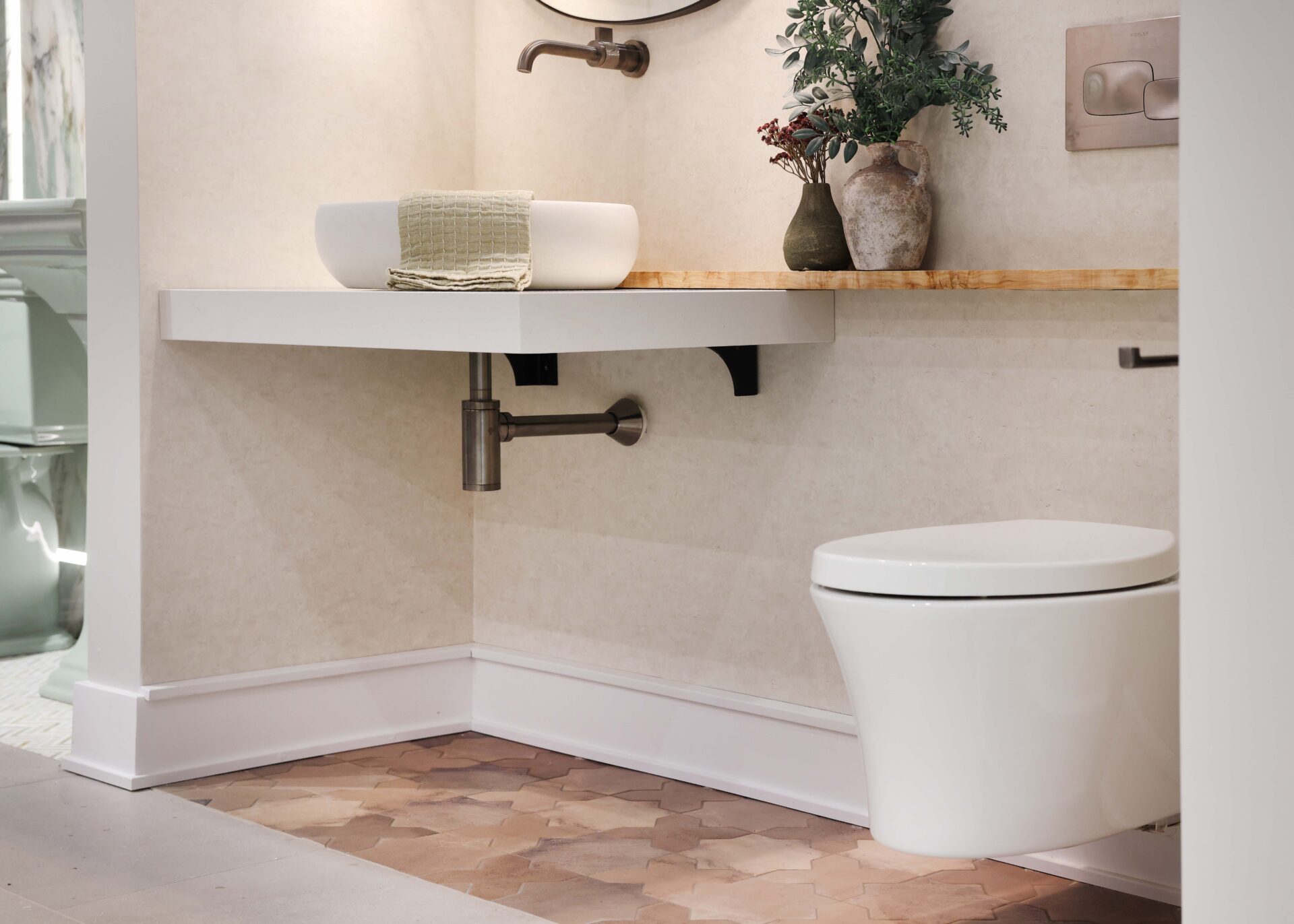 Floating toilet and floating vanity in accessible design powder room, olive wood ledge, porcelain tile flooring, vessel sink, wall-mounted faucet