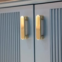Textured teal vanity with gold handles