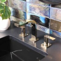 Iridescent tile backsplash in black powder room