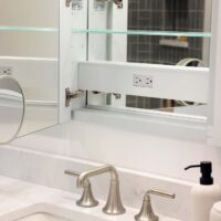 Hall bathroom recessed medicine cabinet with outlet and mirror inside, quartz countertops, brushed nickel faucet