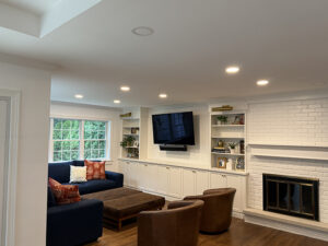 White addition family room with fireplace and TV