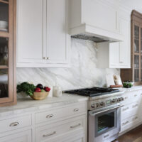 Classic Elmhurst Kitchen features a full height slab backsplash behind a 36-inch range.