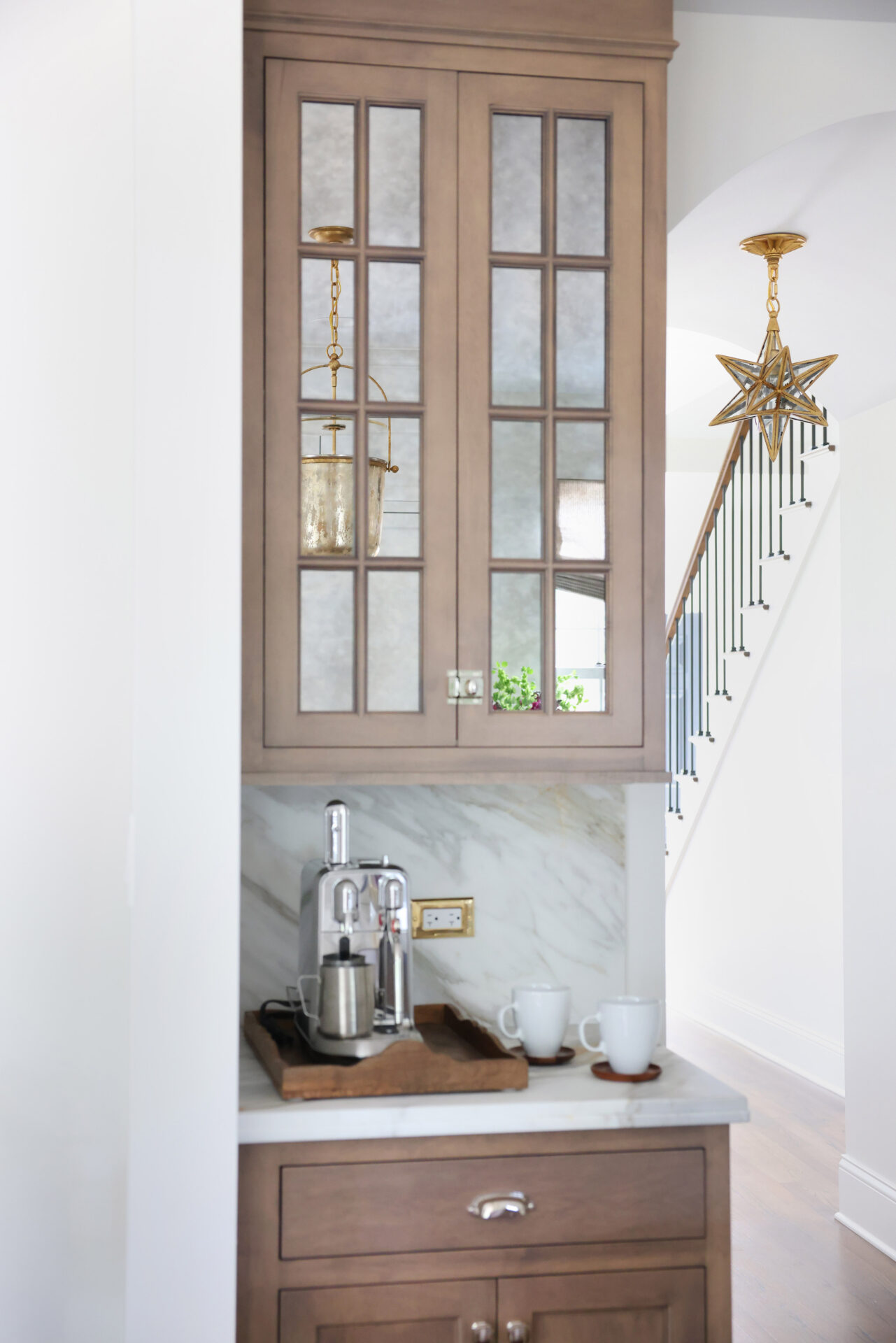 Classic Elmhurst Kitchen features antique mirror on the beverage cabinets, concealing contents and adding light.