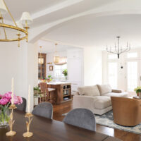 Classic Elmhurst Kitchen and First Floor Renovation includes an arched passageway between the dining room and family room. The arch motif is repeated in the kitchen island in the background.
