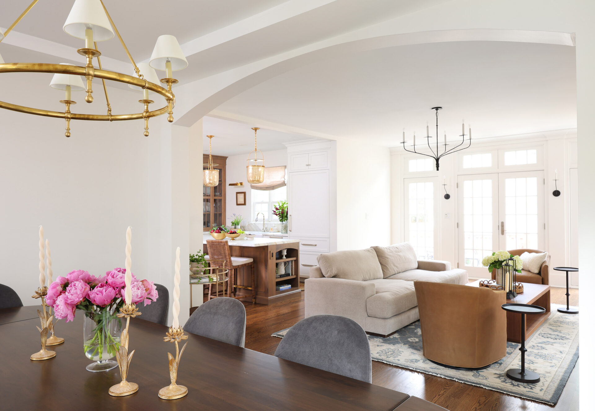 Classic Elmhurst Kitchen and First Floor Renovation includes an arched passageway between the dining room and family room. The arch motif is repeated in the kitchen island in the background.