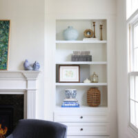 Classic Elmhurst Kitchen and First Floor Renovation includes a front room with built-in shelving and a cozy fireplace.