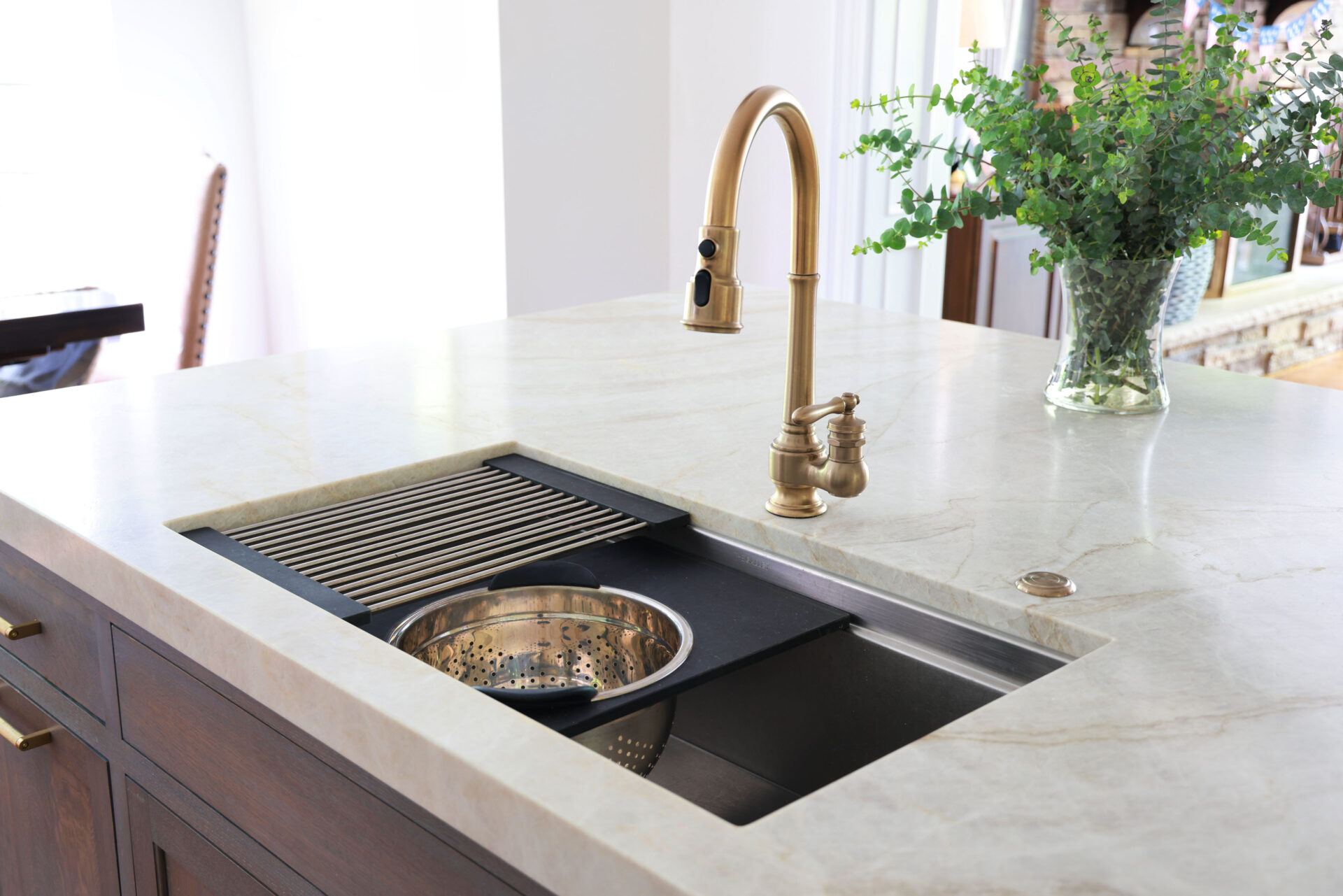 Updated traditional kitchen: The workstation sink includes a handy ledge for accessories, in this case a dish drainer and a colander.
