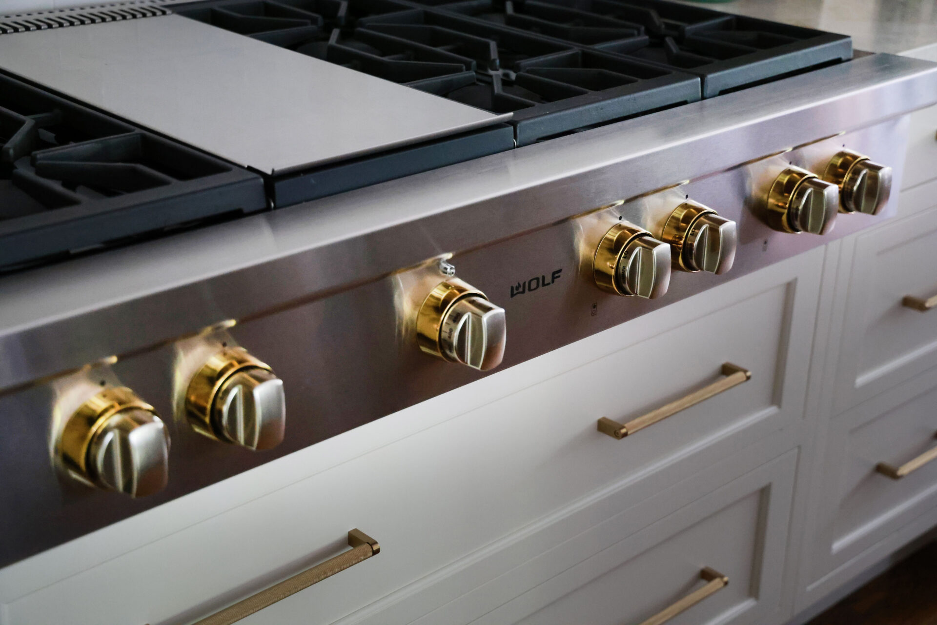 Updated traditional kitchen: Warm metals such as gold and brass feature throughout the kitchen design - including on the selector bezels on this 48-inch range from Wolf-Sub-Zero.