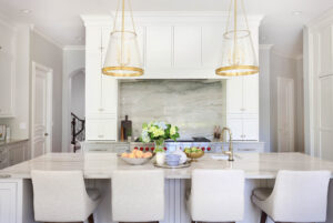 Blue-gray quartzite, gold kitchen lighting, tall cabinets, polished nickel, kitchen island with seating