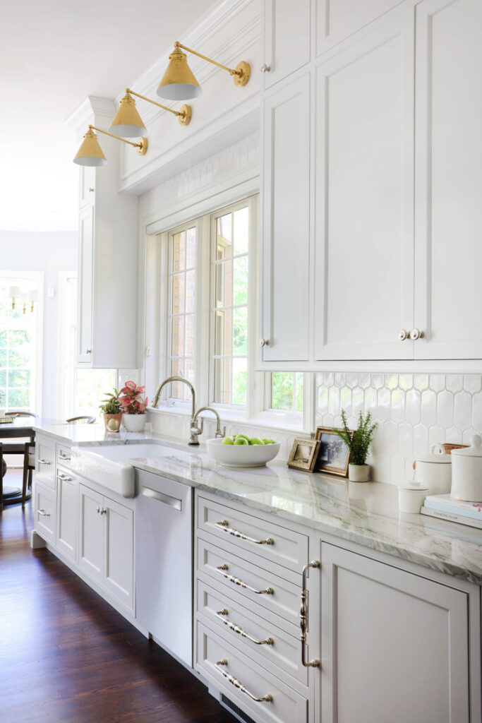 Farmhouse sink by window in new traditional kitchen