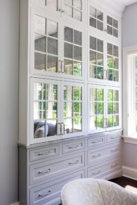 White & gray custom cabinet with polished nickel hardware and antique mirrors