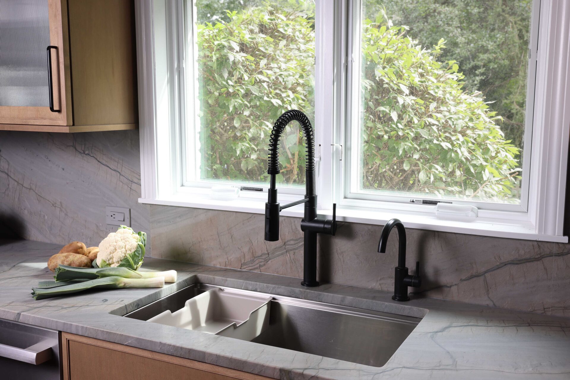 Workstation sink accessories are made with versatility in mind. The container in this sink can be used for food prep or cleanup.