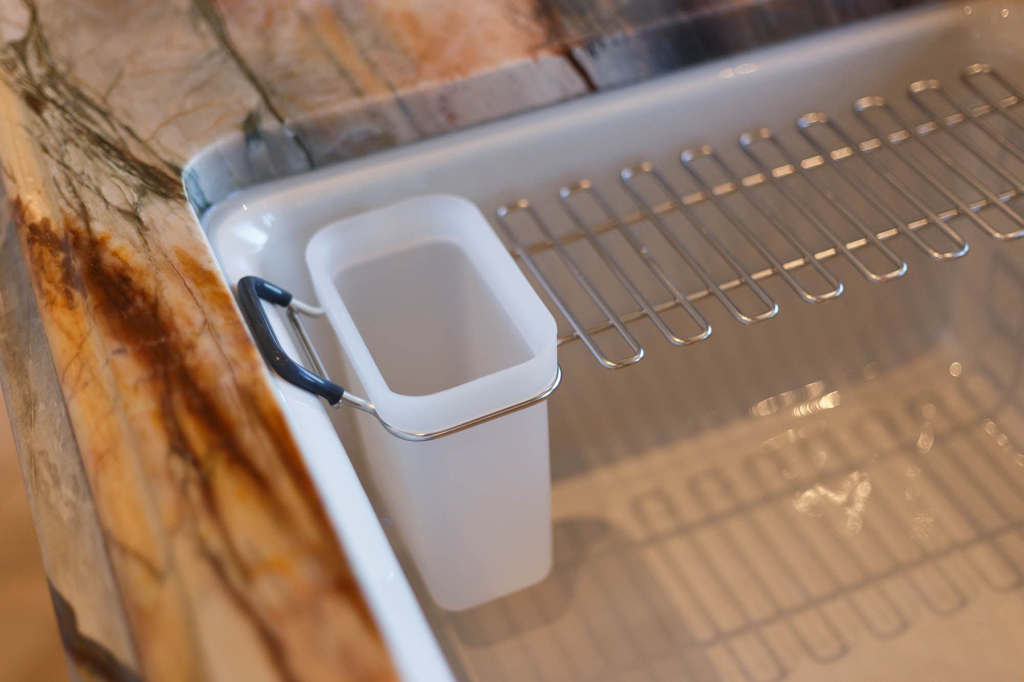 Workstation sink accessories sit on a built-in ledge, adding convenience and functionality to this kitchen design.