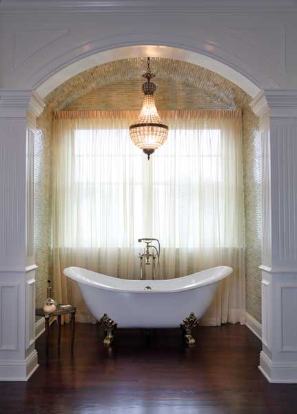 Barrel ceiling rises above a vintage-inspired bathtub.